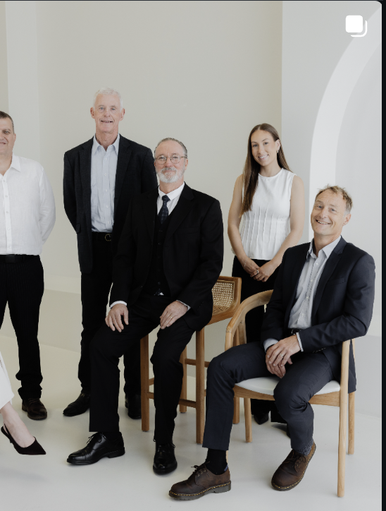 The law firm team photographed together in a bright office