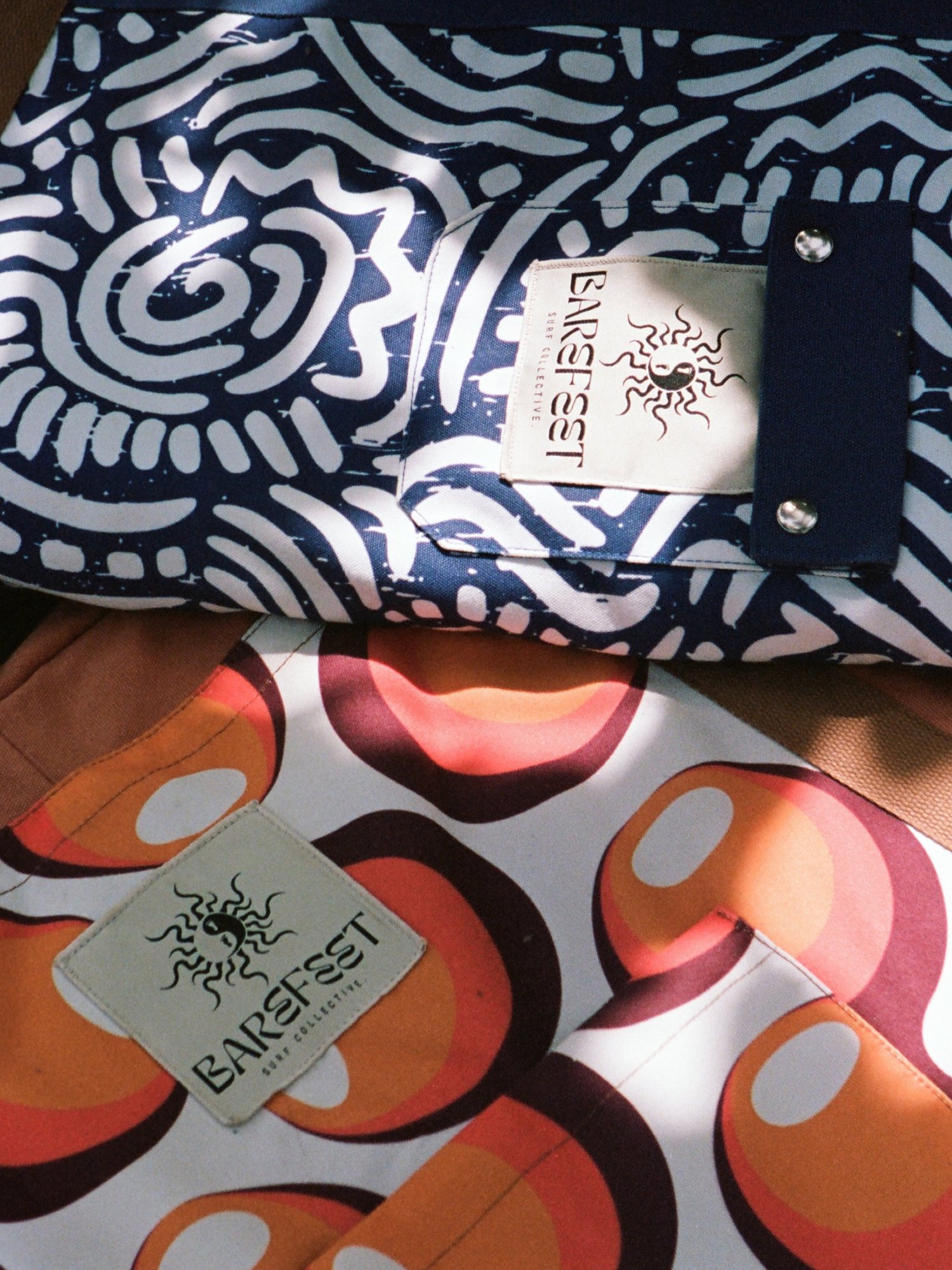 Close-up of patterned Barefeet Surf board bags and branded labels