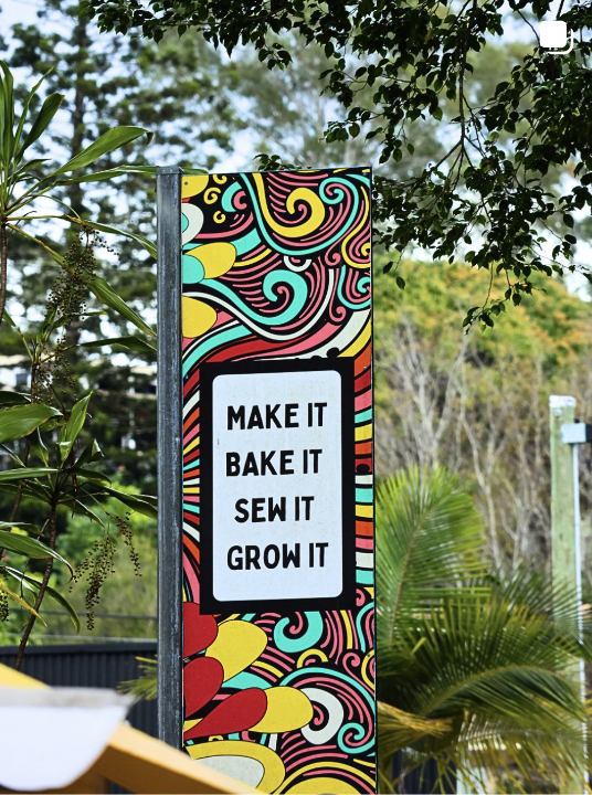 Colourful market sign reading Make it, bake it, sew it, grow it